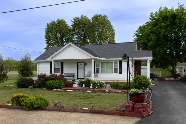a front view of a house with a garden