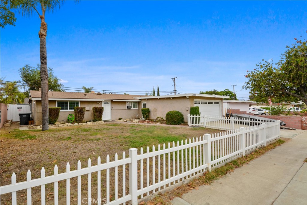 a view of a house with wooden fence