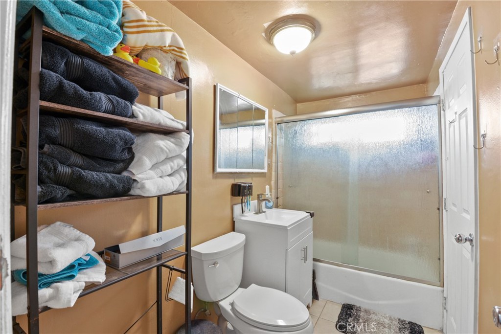 14049 Foster Road La Mirada, CA 90638 - Photo 12 of 16 a bathroom with a toilet a sink and a shower