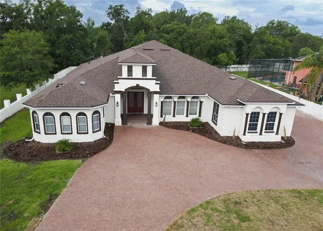 a aerial view of a house next to a yard