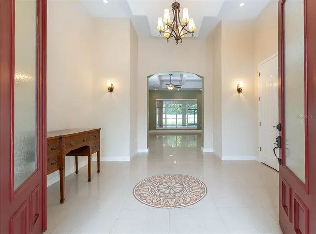 a hallway with a chandelier and a chandelier