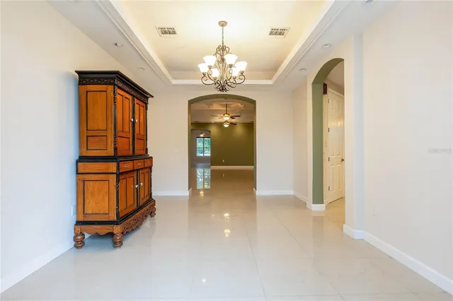 a large white kitchen with stainless steel appliances