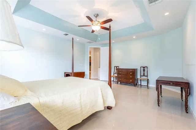 a spacious bathroom with a tub sink and mirror