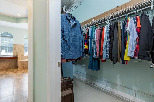 a spacious bathroom with windows a bathtub and a large window