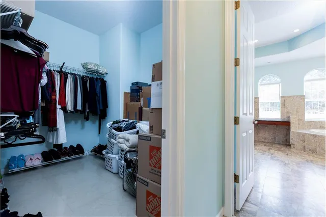 a spacious bedroom with a bed and a dresser