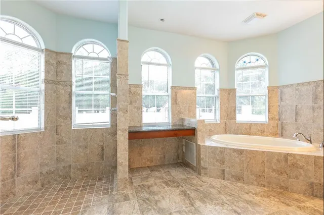 an empty room with closet and windows