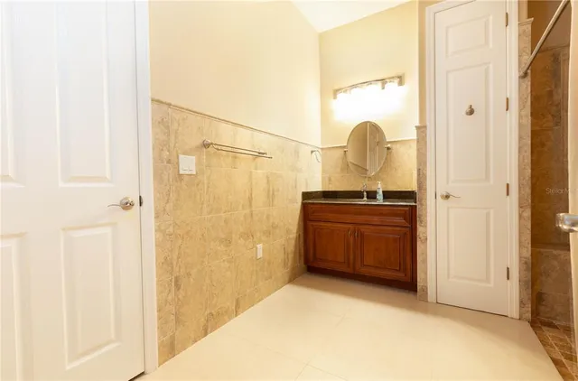 an aerial view of a house with a garden and lake view