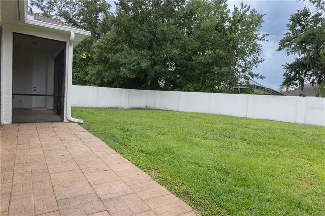 a view of an empty room with closet and a window