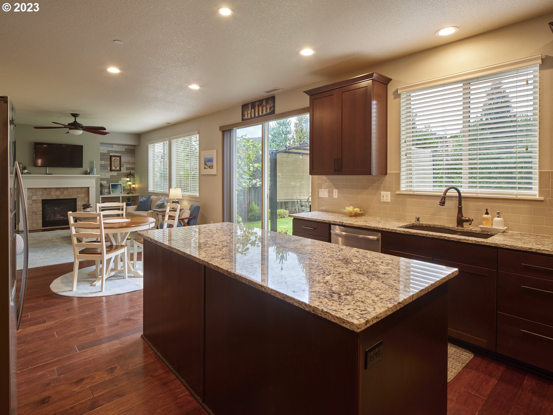 1424 Northwest Goodwin Street Camas, WA 98607 - Photo 16 of 40 a kitchen with granite countertop a stove a sink a dining table and chairs