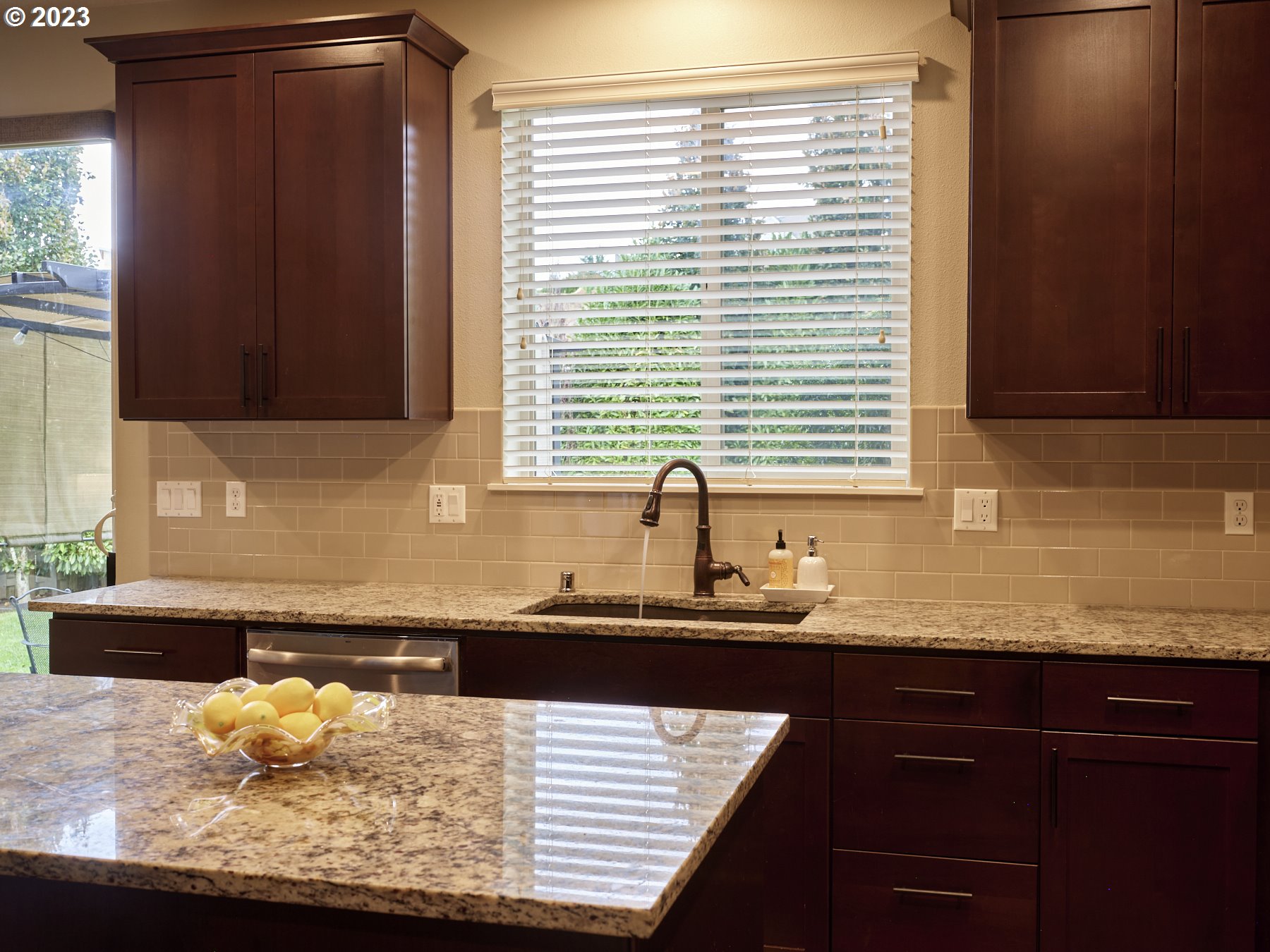 1424 Northwest Goodwin Street Camas, WA 98607 - Photo 18 of 40 a kitchen with granite countertop white cabinets and a sink