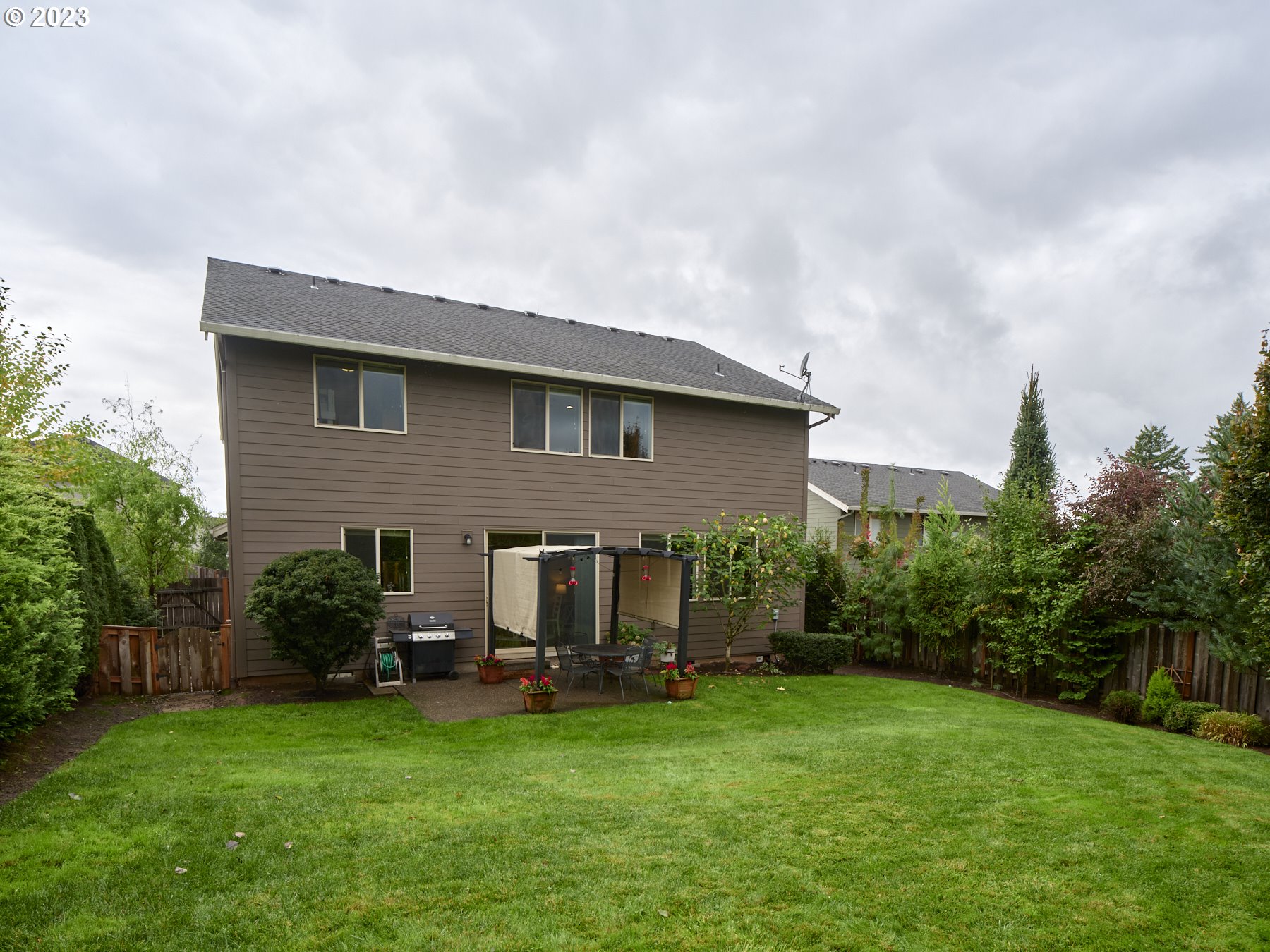 1424 Northwest Goodwin Street Camas, WA 98607 - Photo 38 of 40 a view of a house with backyard sitting area and garden
