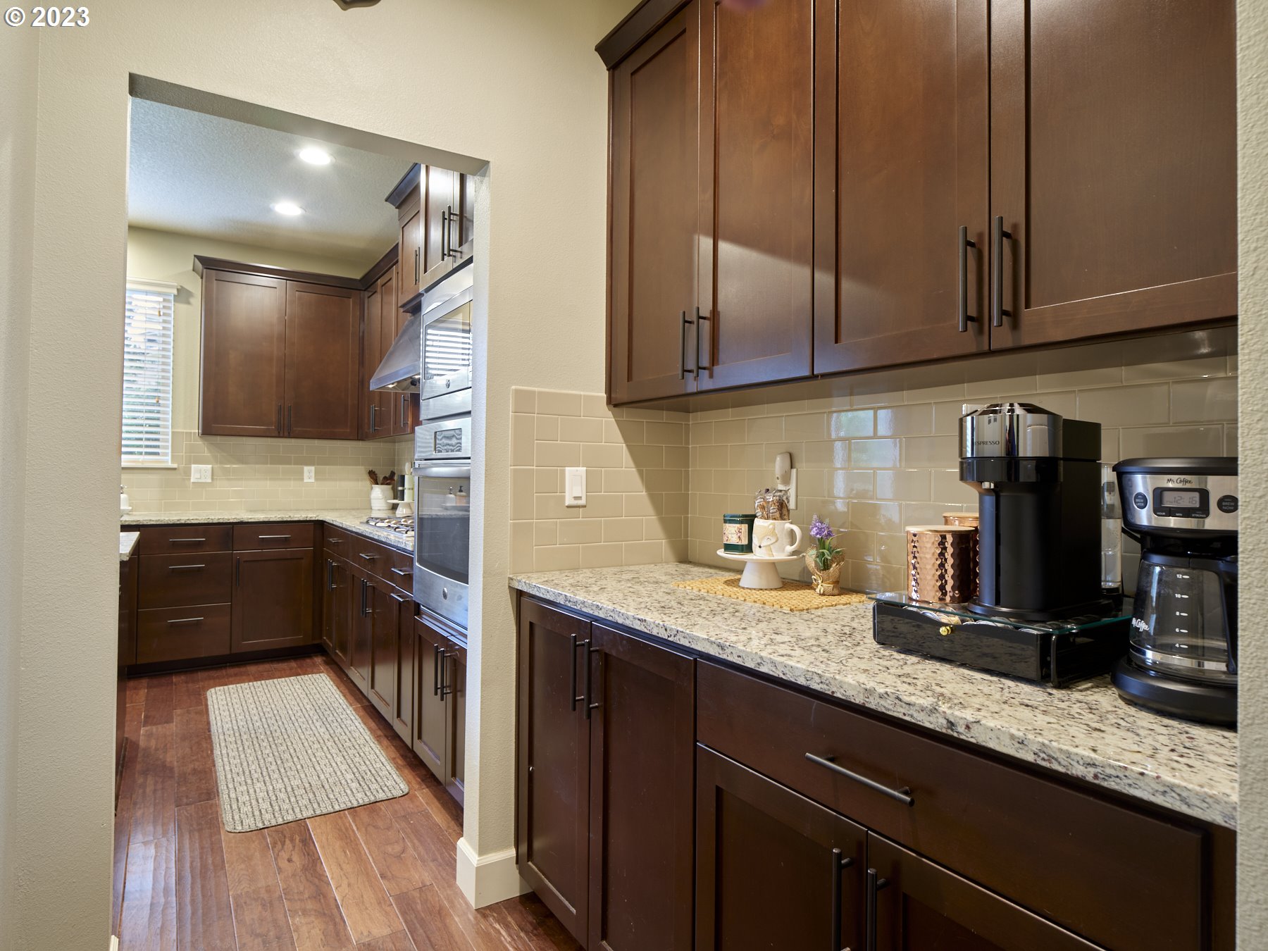 1424 Northwest Goodwin Street Camas, WA 98607 - Photo 10 of 40 a kitchen with granite countertop cabinets and wooden floor