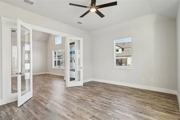 a kitchen with white cabinets and appliances
