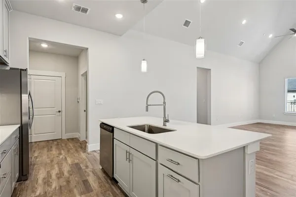 an empty room with chandelier fan