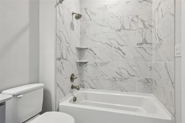 a bathroom with a shower sink and mirror