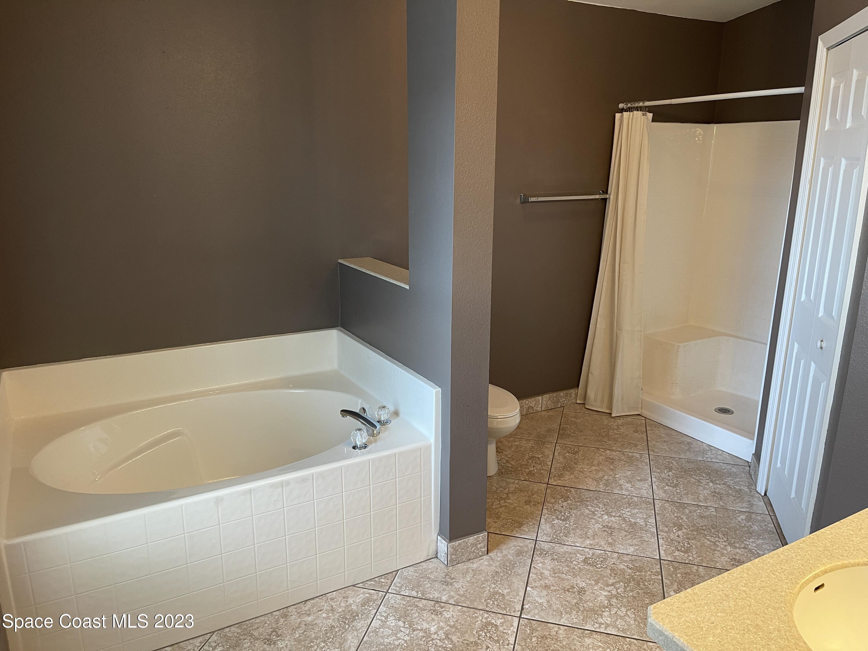 527 Melanie Circle Melbourne, FL 32901 - Photo 11 of 18 a white bath tub sitting in a bathroom