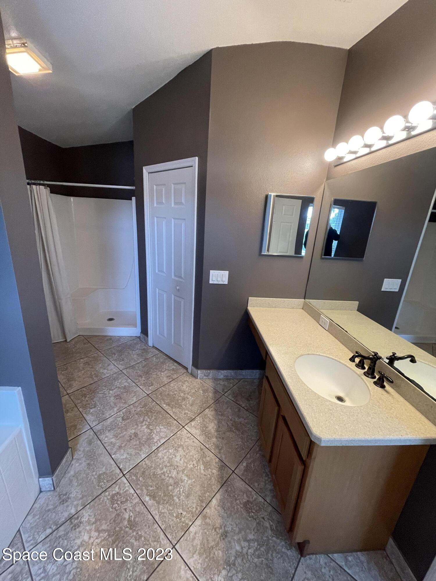 527 Melanie Circle Melbourne, FL 32901 - Photo 12 of 18 a bathroom with a sink and mirror