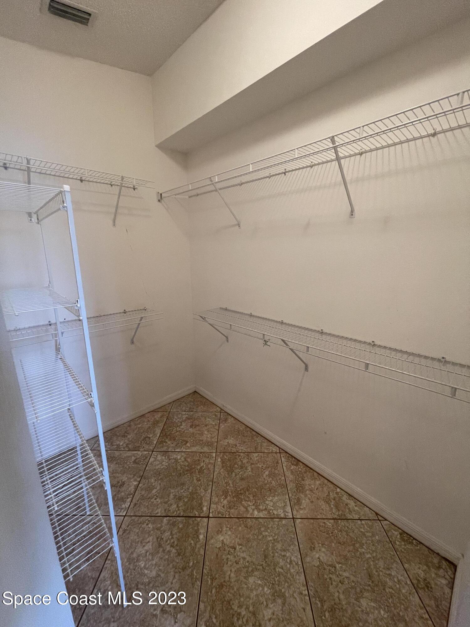 527 Melanie Circle Melbourne, FL 32901 - Photo 13 of 18 a view of a room with racks on the wall