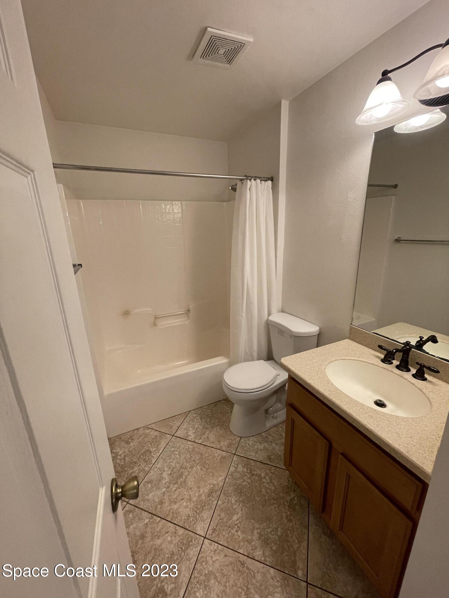 527 Melanie Circle Melbourne, FL 32901 - Photo 15 of 18 a bathroom with a sink toilet and shower
