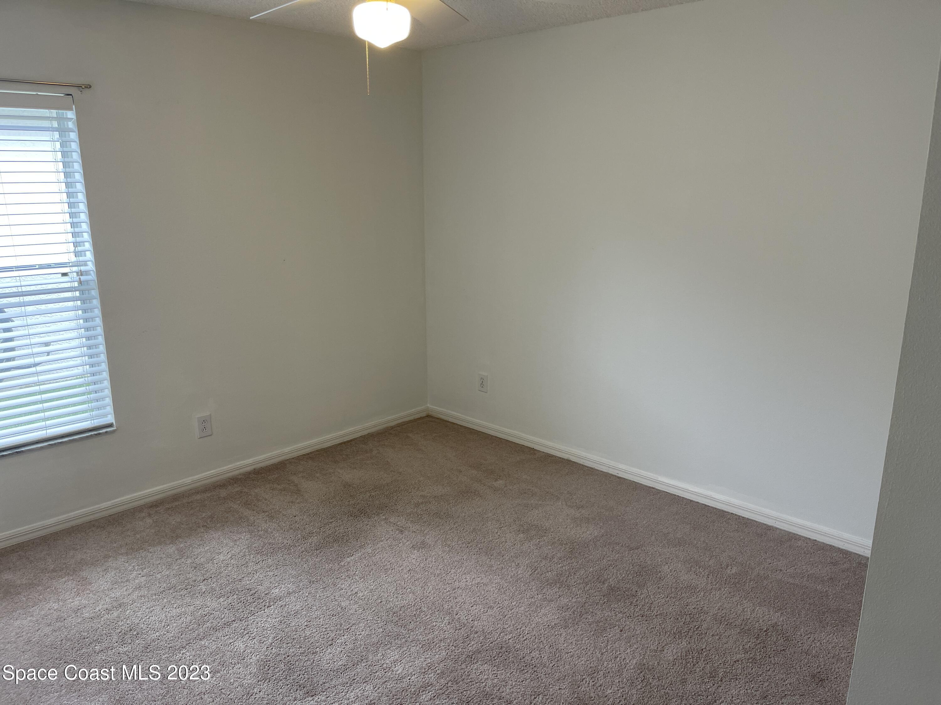 527 Melanie Circle Melbourne, FL 32901 - Photo 16 of 18 a view of an empty room and a window