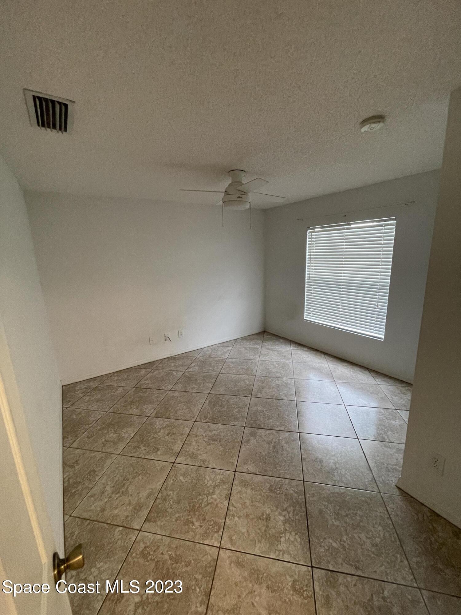 527 Melanie Circle Melbourne, FL 32901 - Photo 17 of 18 a view of an empty room and window