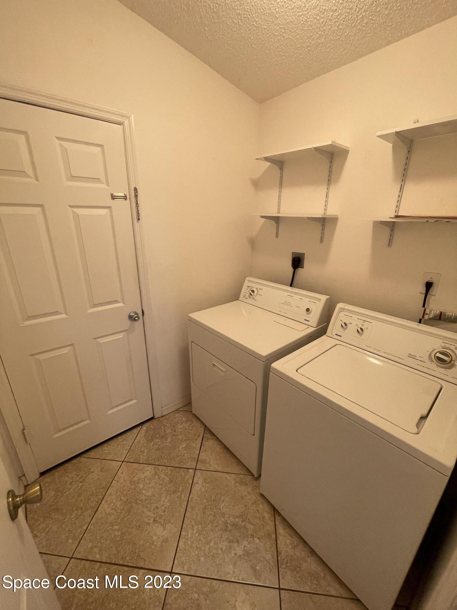 527 Melanie Circle Melbourne, FL 32901 - Photo 18 of 18 a utility room with dryer and washer