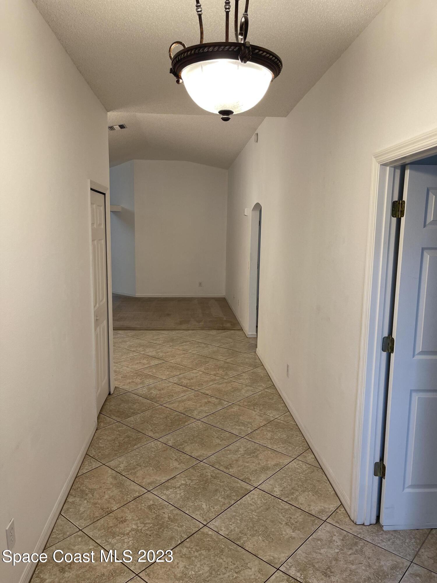 527 Melanie Circle Melbourne, FL 32901 - Photo 2 of 18 a view of a room with a sink and a mirror