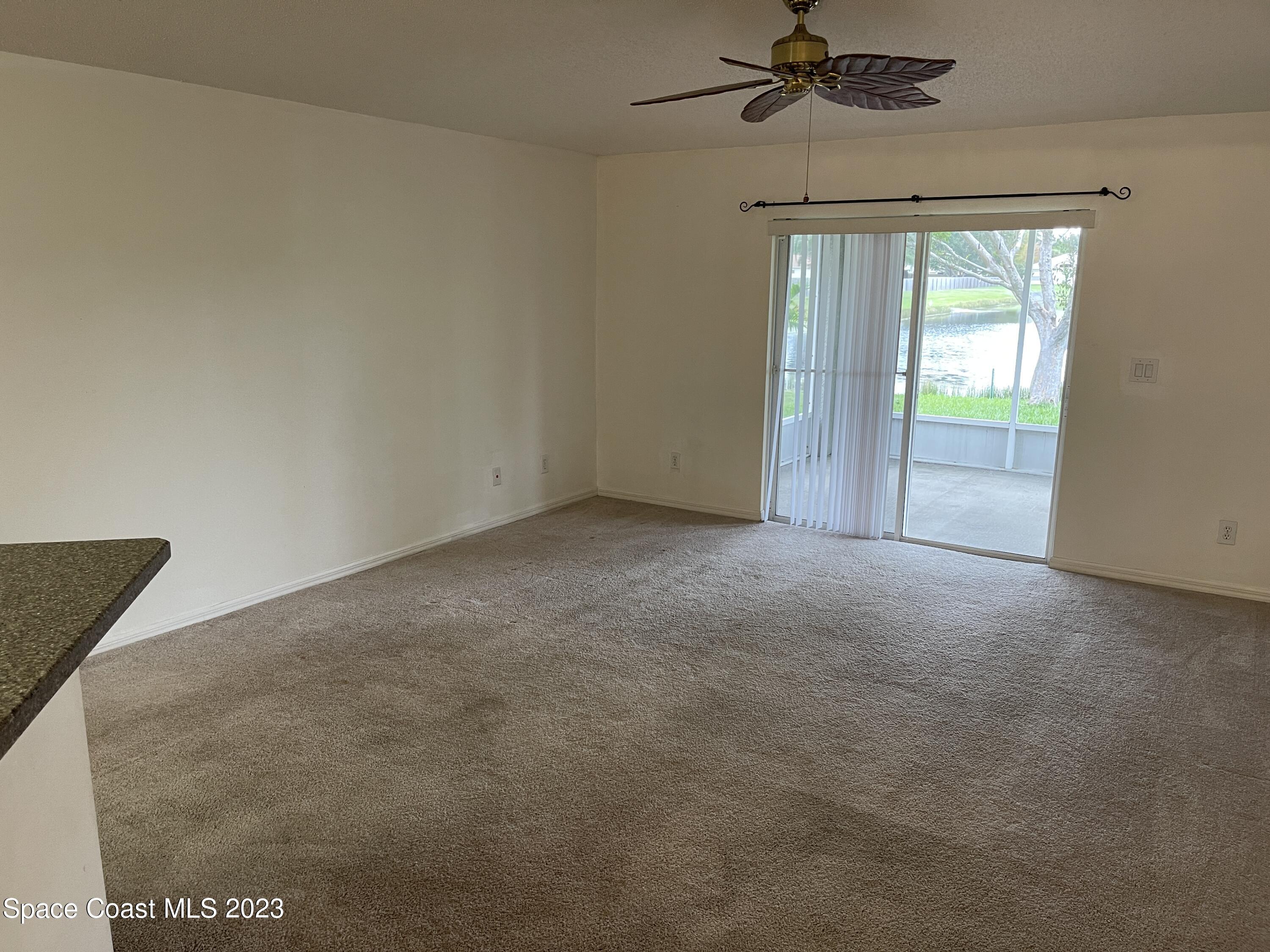 527 Melanie Circle Melbourne, FL 32901 - Photo 5 of 18 a view of an empty room with a window