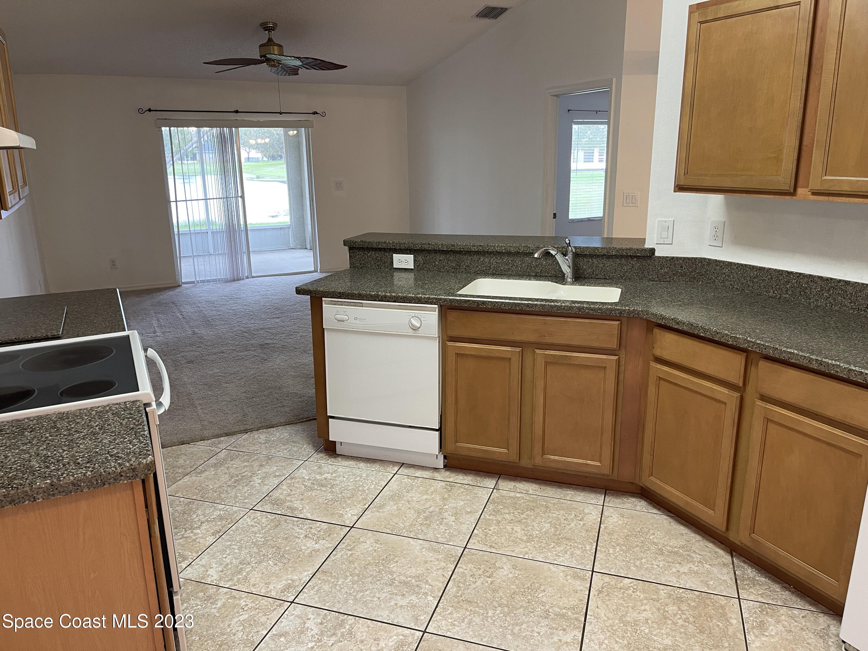 527 Melanie Circle Melbourne, FL 32901 - Photo 7 of 18 a kitchen with a sink and a stove top oven