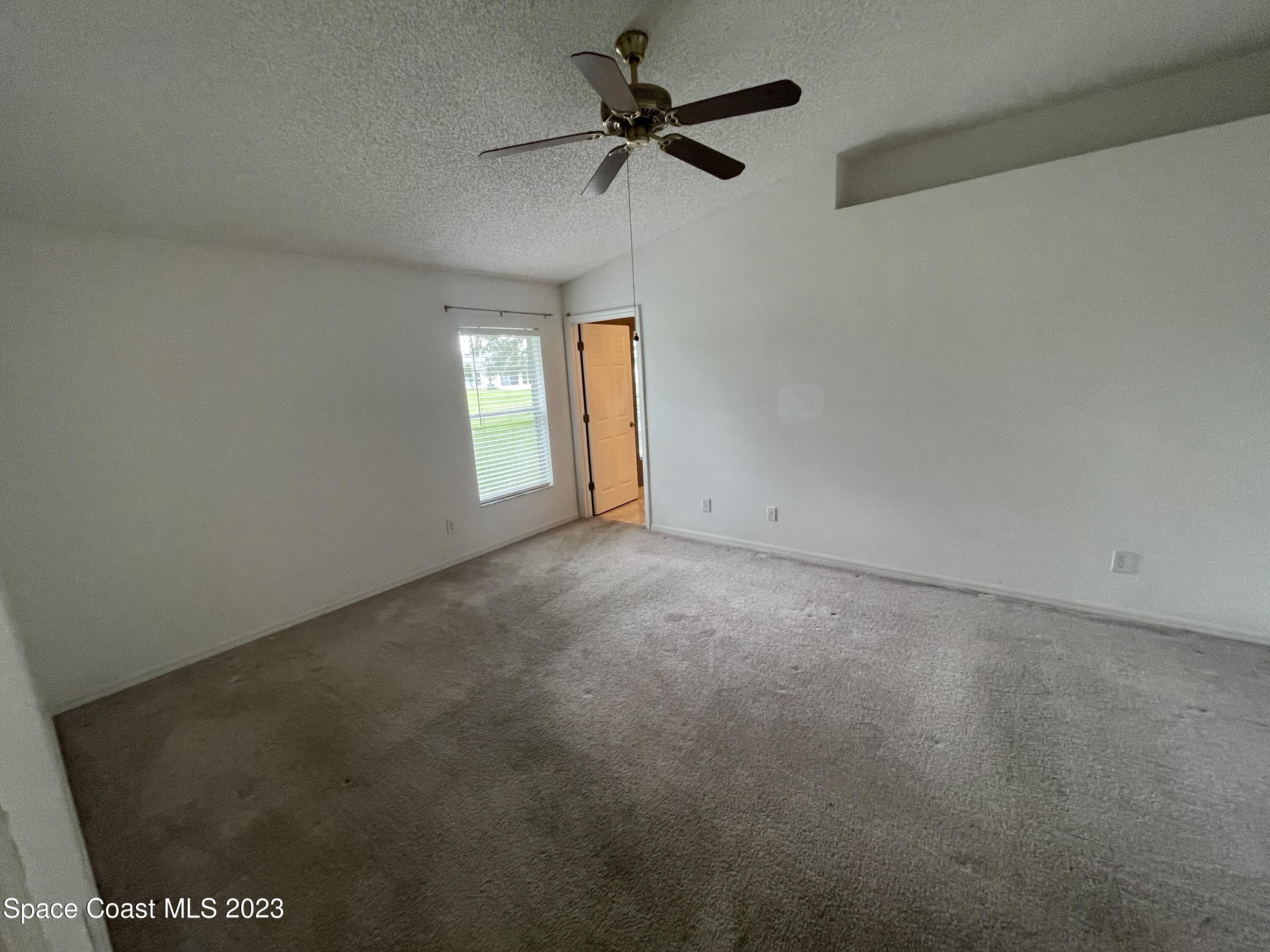 527 Melanie Circle Melbourne, FL 32901 - Photo 9 of 18 a view of an empty room with a window