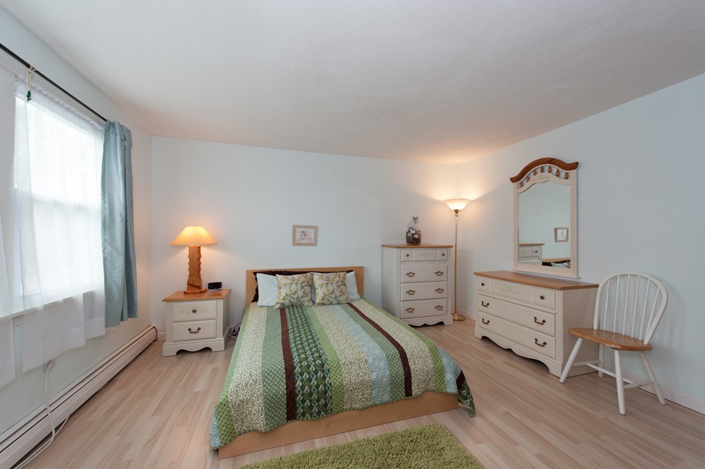 132 Howland Road Lakeville, MA 02347 - Photo 28 of 30 a bedroom with a bed and a chair