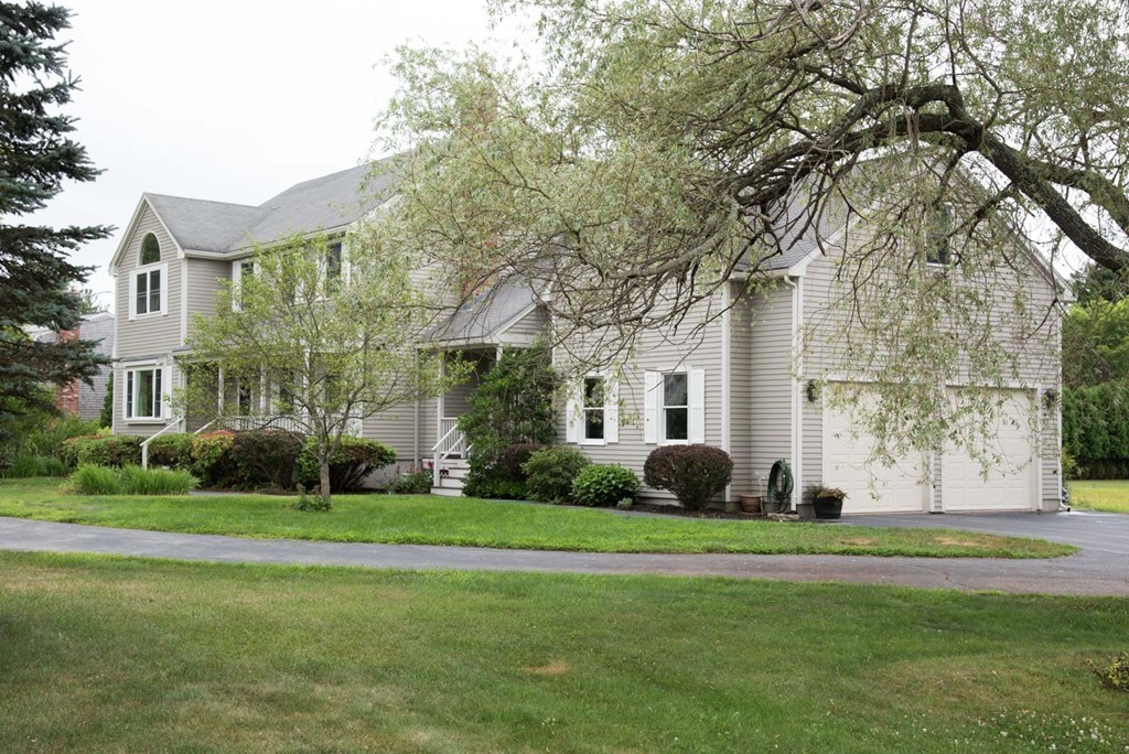 132 Howland Road Lakeville, MA 02347 - Photo 3 of 30 a front view of a building with garden and trees