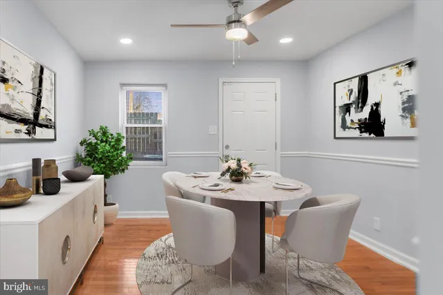 a bedroom with a bed lamp and a potted plant