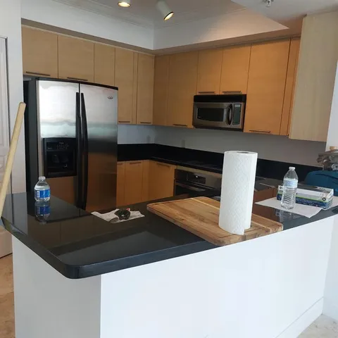 a kitchen with stainless steel appliances a sink a stove a microwave a counter top and cabinets