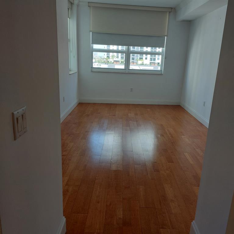 350 Southeast 2nd Street, Unit 1260 Fort Lauderdale, FL 33301 - Photo 5 of 6 an empty room with wooden floor and windows