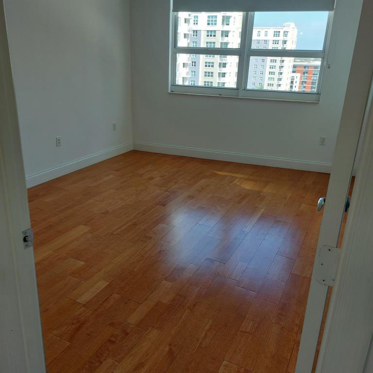 350 Southeast 2nd Street, Unit 1260 Fort Lauderdale, FL 33301 - Photo 6 of 6 an empty room with wooden floor and windows