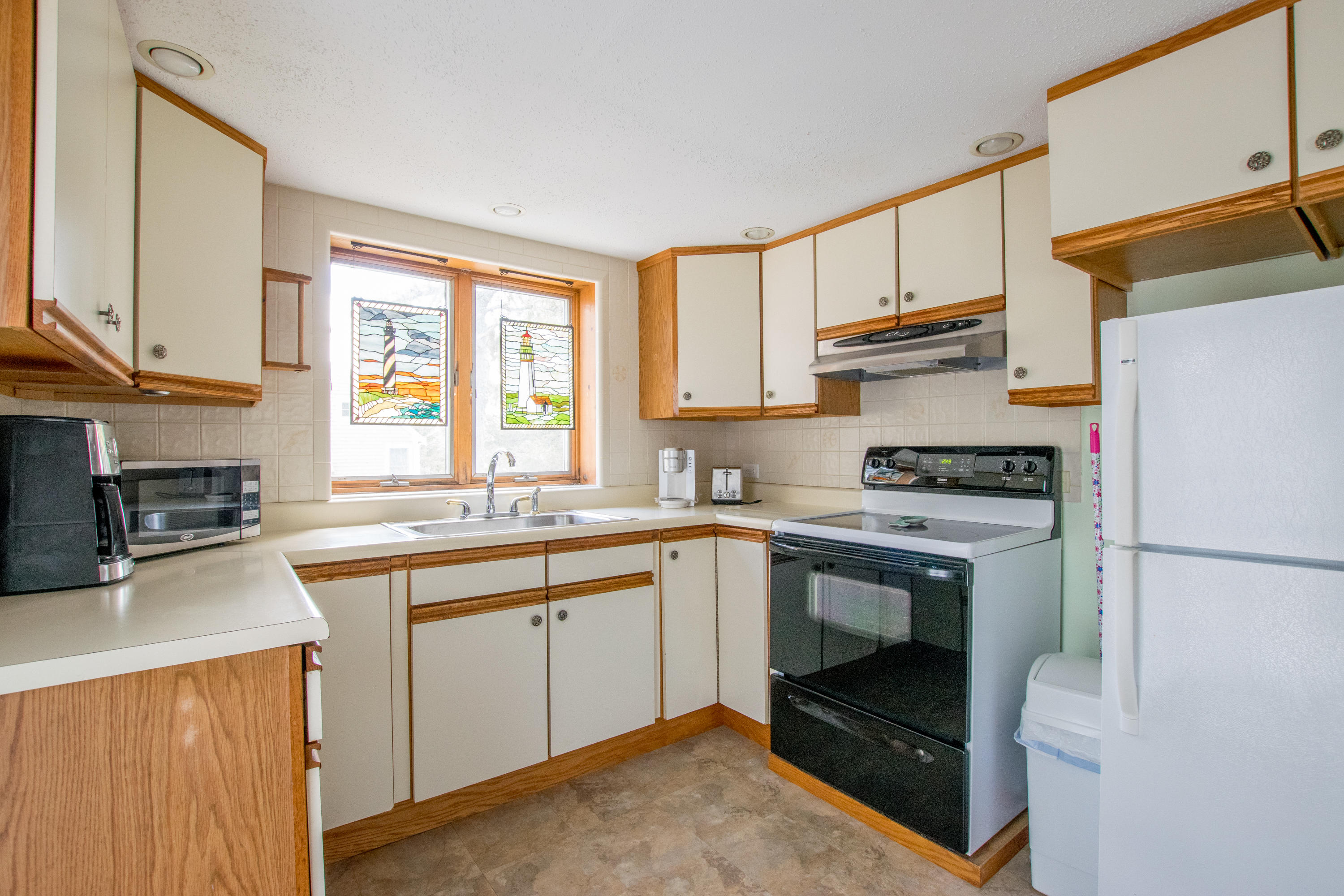 60 Youngs Road Chatham, MA 02633 - Photo 11 of 21 a kitchen with a sink a stove a refrigerator and cabinets