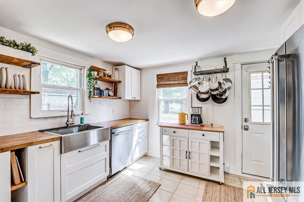121 East Cliff Road Colonia, NJ 07067 - Photo 13 of 35 a kitchen with stainless steel appliances a sink and a cabinets
