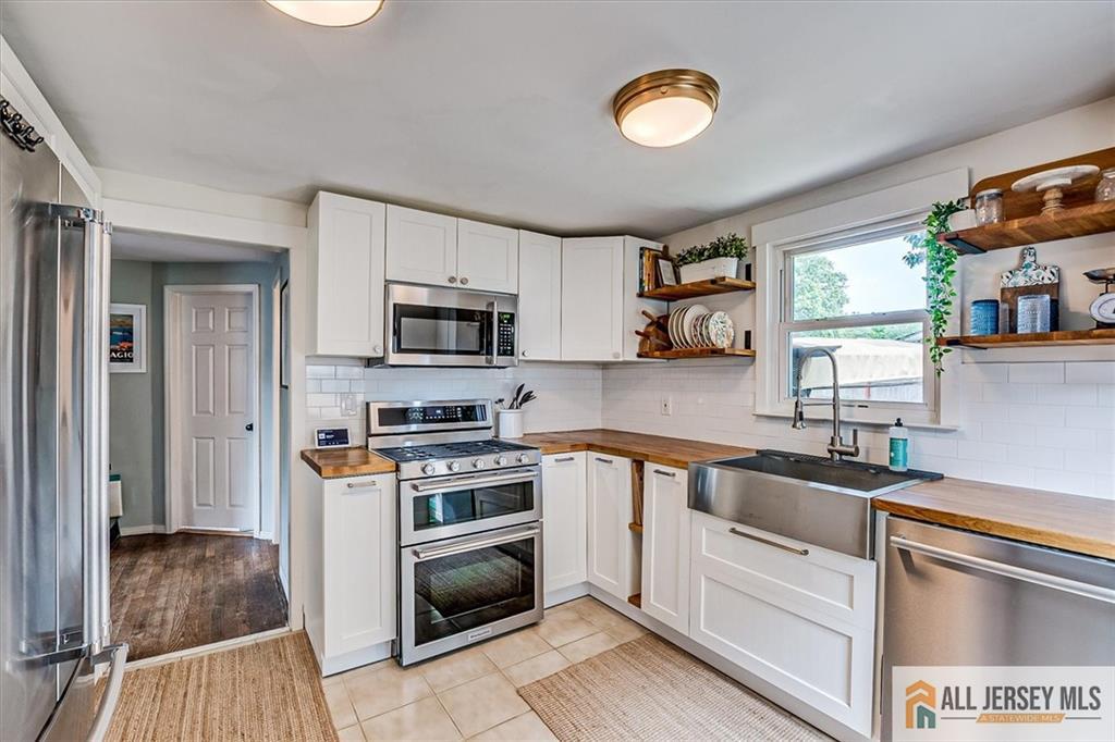 121 East Cliff Road Colonia, NJ 07067 - Photo 14 of 35 a kitchen with a sink stove and microwave