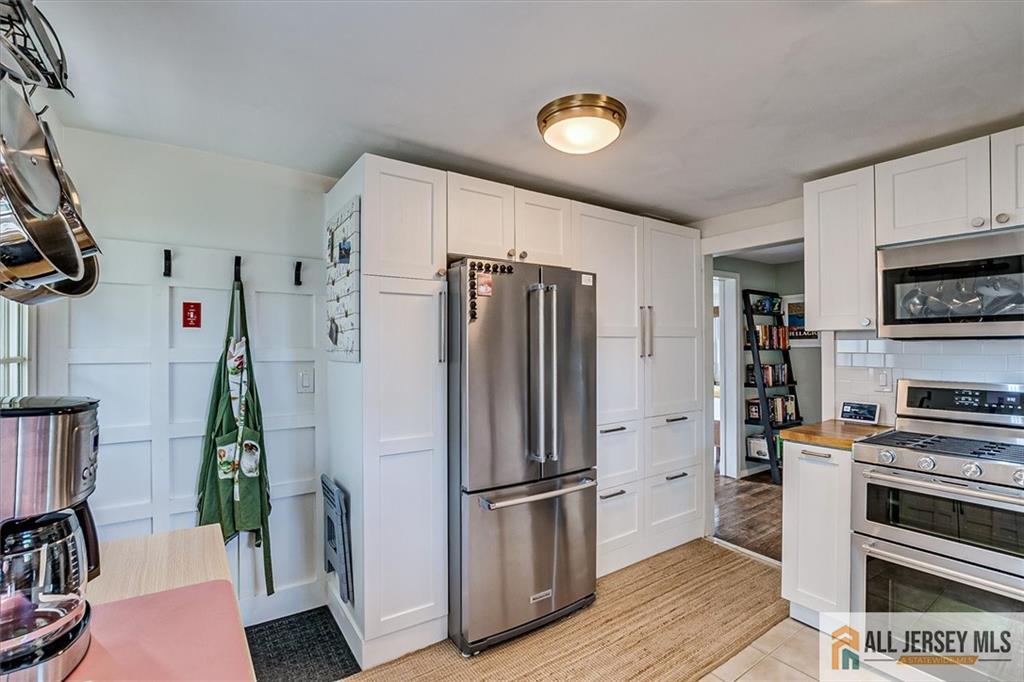 121 East Cliff Road Colonia, NJ 07067 - Photo 17 of 35 a kitchen with stainless steel appliances a refrigerator and a stove top oven