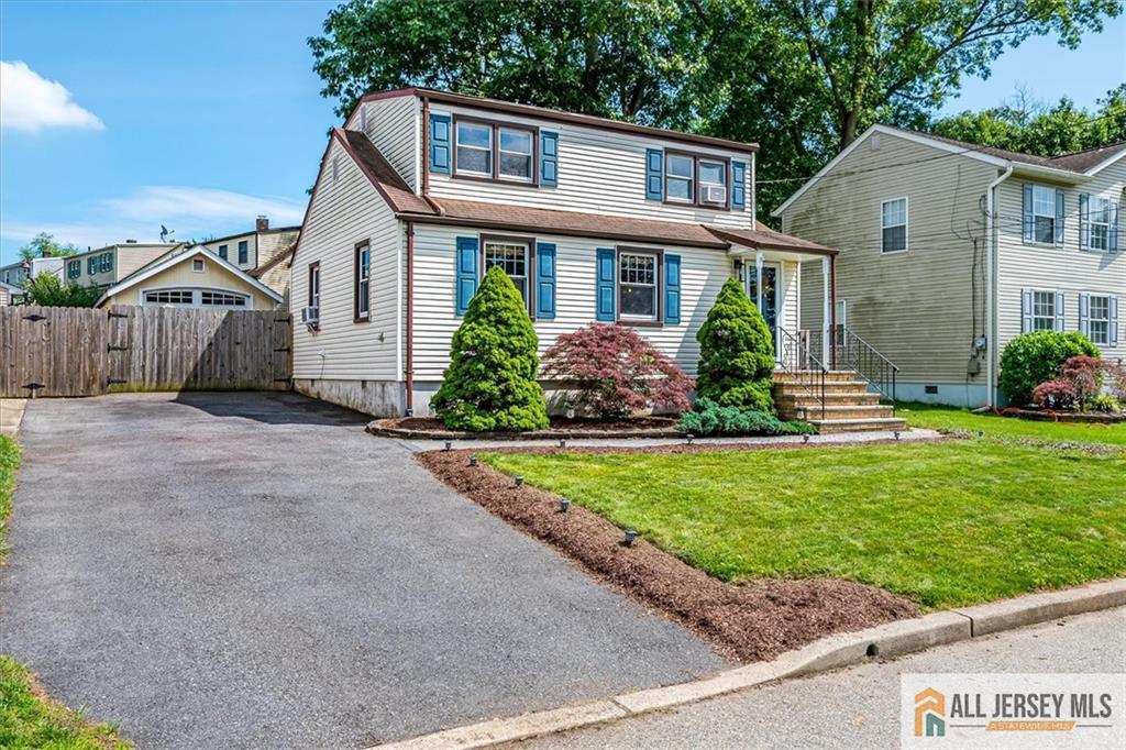 121 East Cliff Road Colonia, NJ 07067 - Photo 2 of 35 a front view of a house with a yard and potted plants