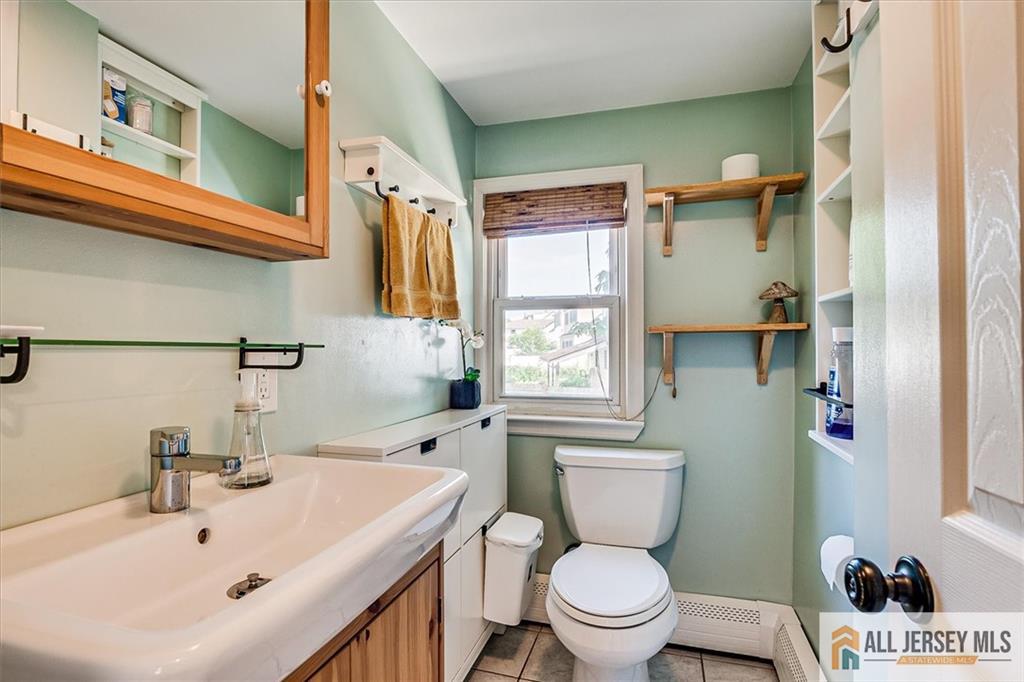 121 East Cliff Road Colonia, NJ 07067 - Photo 27 of 35 a bathroom with a sink a toilet and shower curtain