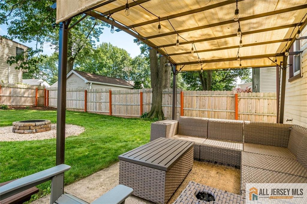 121 East Cliff Road Colonia, NJ 07067 - Photo 30 of 35 a view of a patio with couches and table with wooden floor and fence