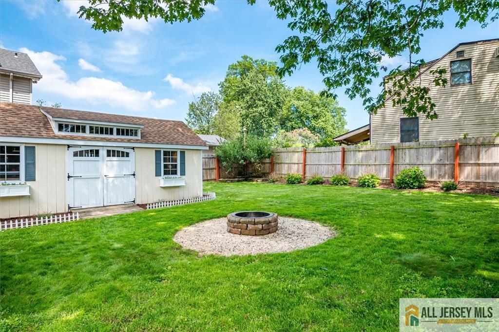 121 East Cliff Road Colonia, NJ 07067 - Photo 34 of 35 a view of a house with a backyard and a patio