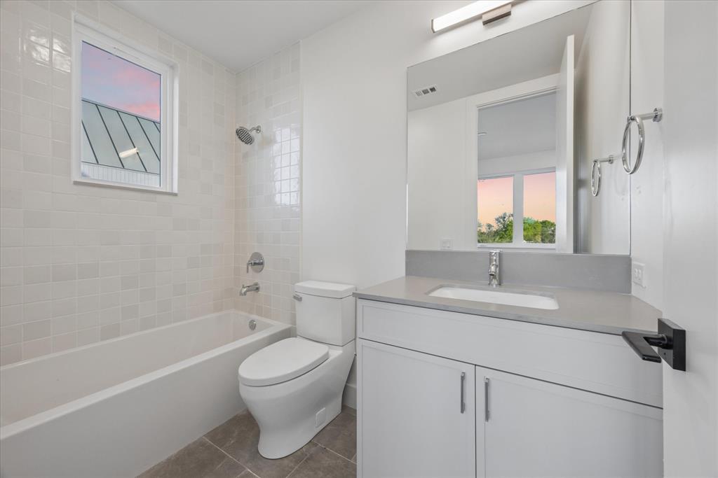 4101 Menchaca Road, Unit 102 Austin, TX 78704 - Photo 10 of 14 Refined tile work enhances the clean lines of this modern bathroom.
