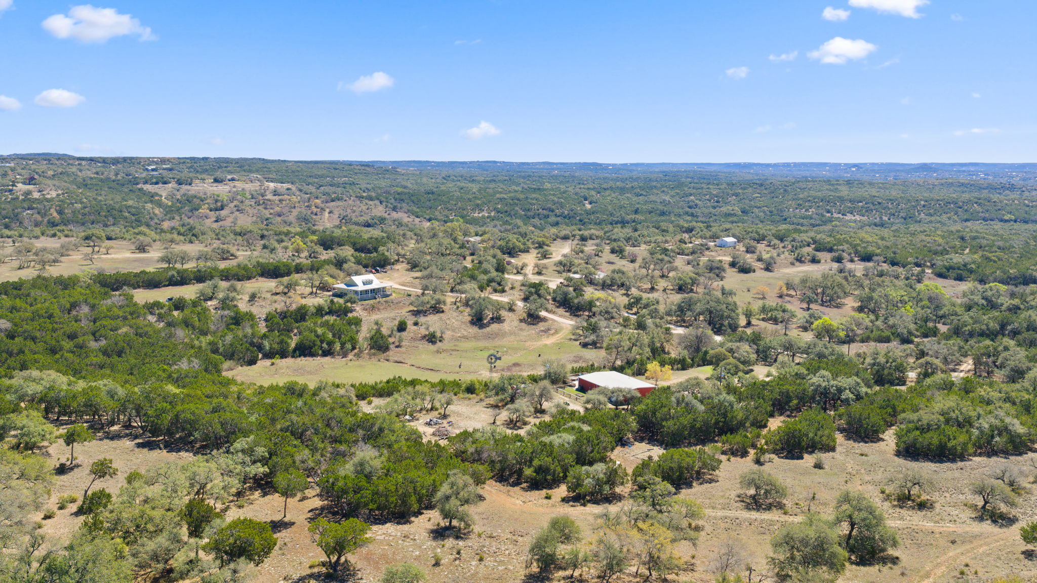6350 Mt Sharp Road, Unit B Wimberley, TX 78676 - Photo 33 of 34 an aerial view of residential houses with outdoor space and trees