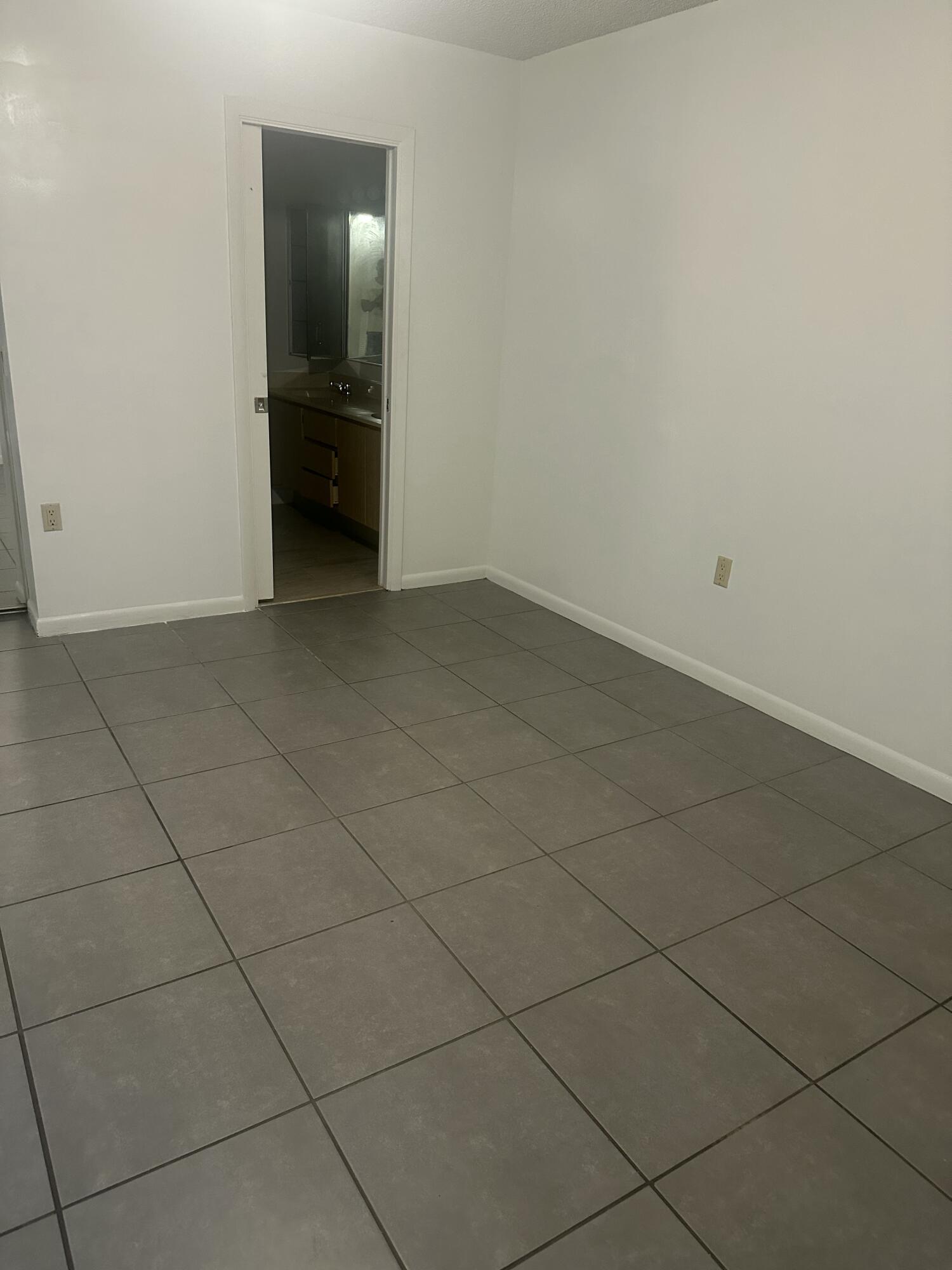 5834 58th Way West Palm Beach, FL 33409 - Photo 11 of 14 an empty room with a bench