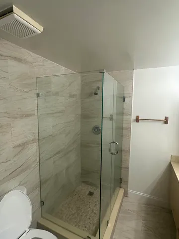 a bathroom with a shower and toilet