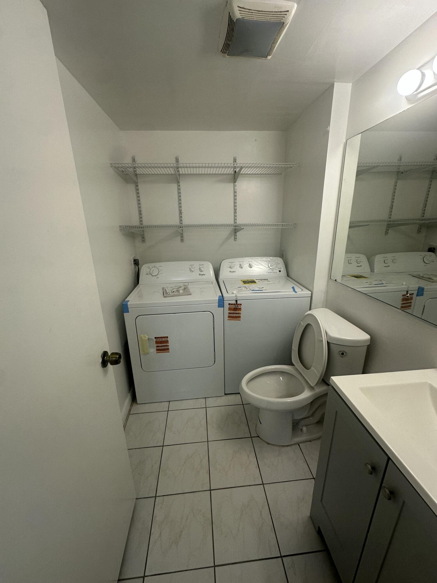5834 58th Way West Palm Beach, FL 33409 - Photo 6 of 14 a utility room with dryer and washer