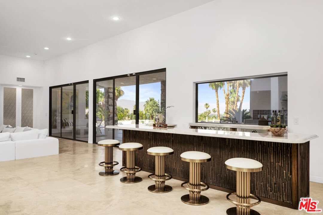 70255 Thunderbird Road Rancho Mirage, CA 92270 - Photo 18 of 53 a kitchen with a sink and chairs